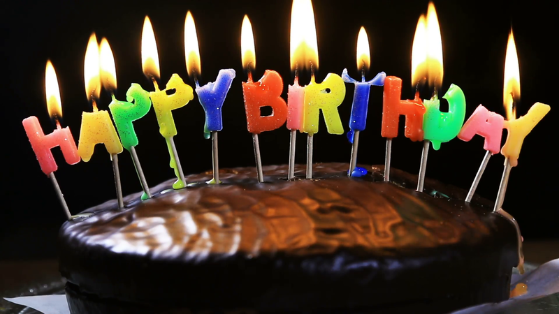 lighted-candles-on-a-happy-birthday-cake-candles-with-the-words-happy-birthday-on-a-chocolate-cake-hand-lights-a-candle-happy-birthday_rz7gcacv__F0009.png
